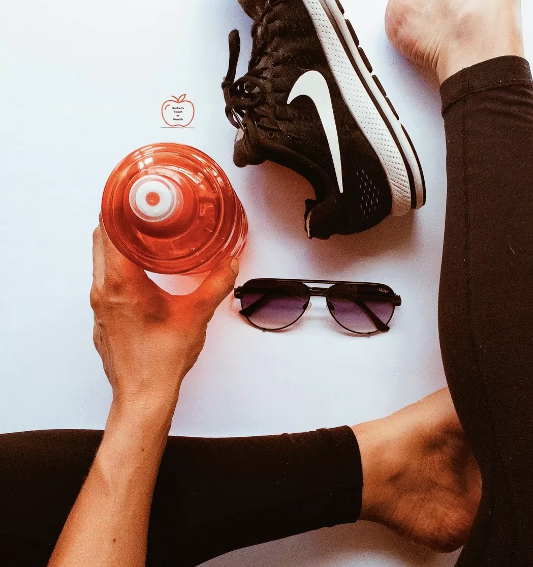A person wearing exercise clothes, holding a water bottle, symbolising hydration and fitness commitment in a 25-week nutrition and fitness program.