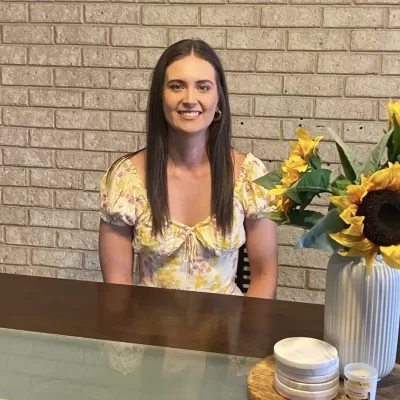 A personal photo of the weight loss nutritionist and personal trainer, smiling and approachable, inviting clients to connect with their supportive guide.