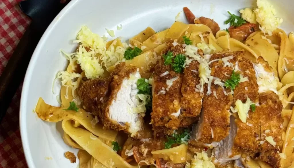 A photo of a delicious plate of chicken pasta, showcasing a nutritious meal option provided by our online weight loss nutritionist and personal trainer.