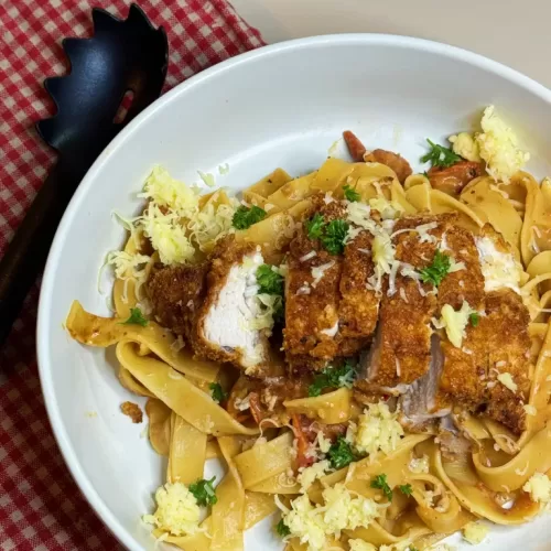 A photo of a delicious plate of chicken pasta, showcasing a nutritious meal option provided by our online weight loss nutritionist and personal trainer.