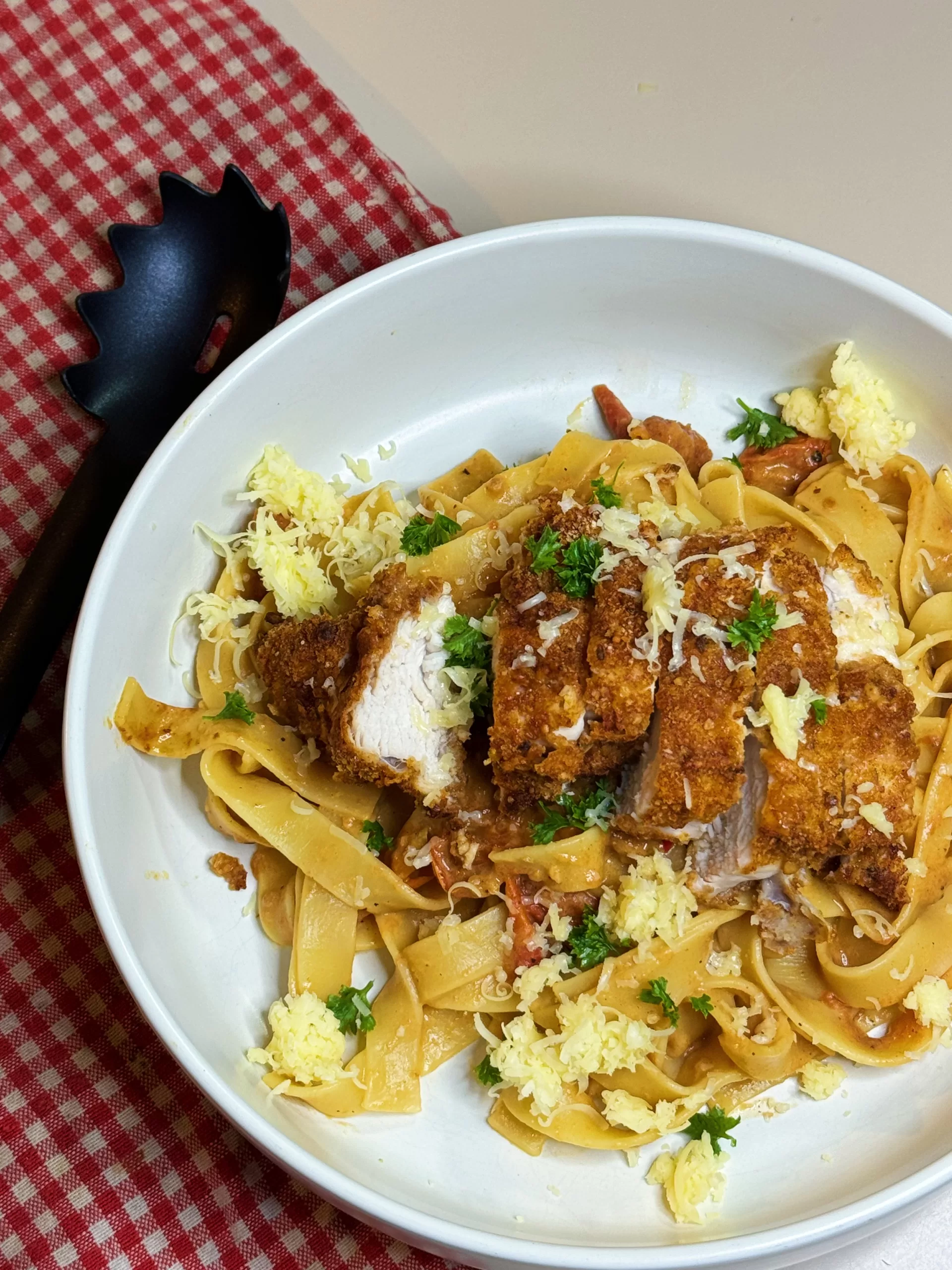 A photo of a delicious plate of chicken pasta, showcasing a nutritious meal option provided by our online weight loss nutritionist and personal trainer.